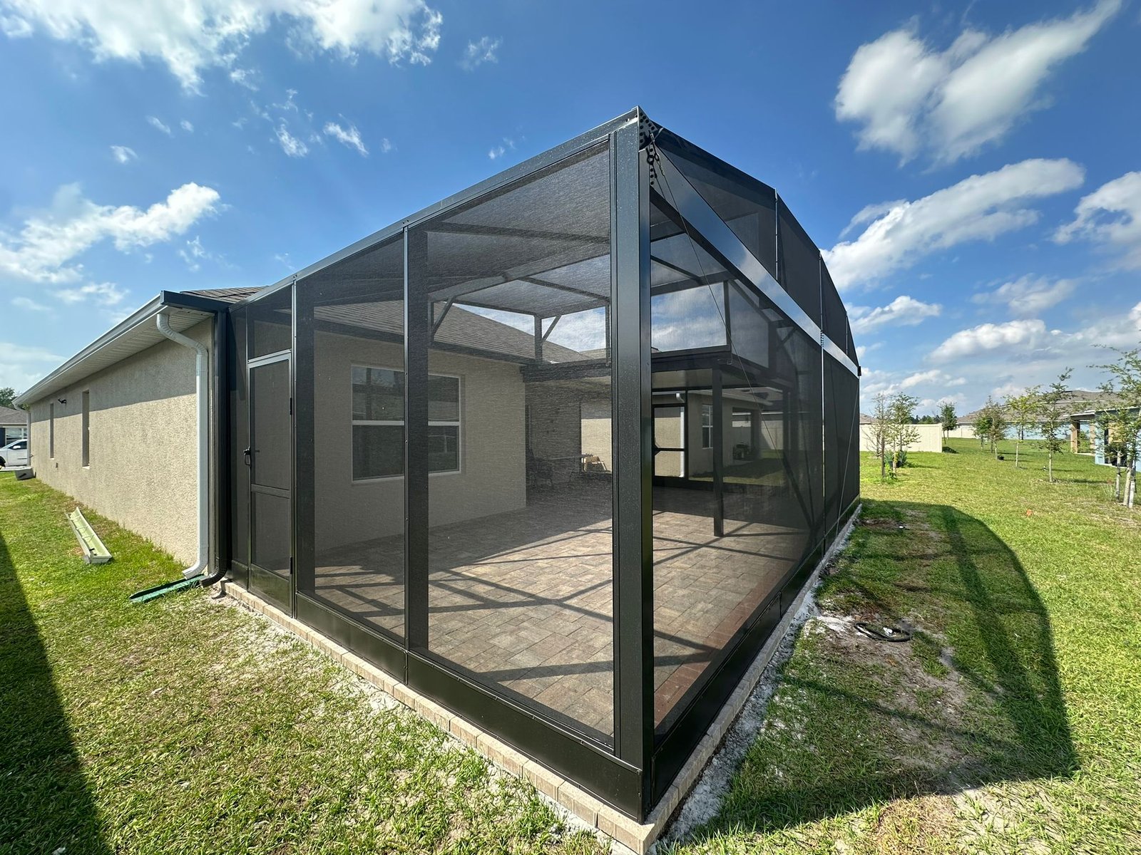 Screened-in pool in Florida with panoramic clear-view beams