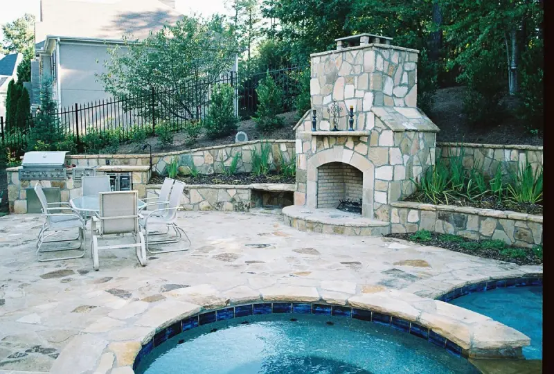 Florida pool water features with stone waterfall and fire bowls