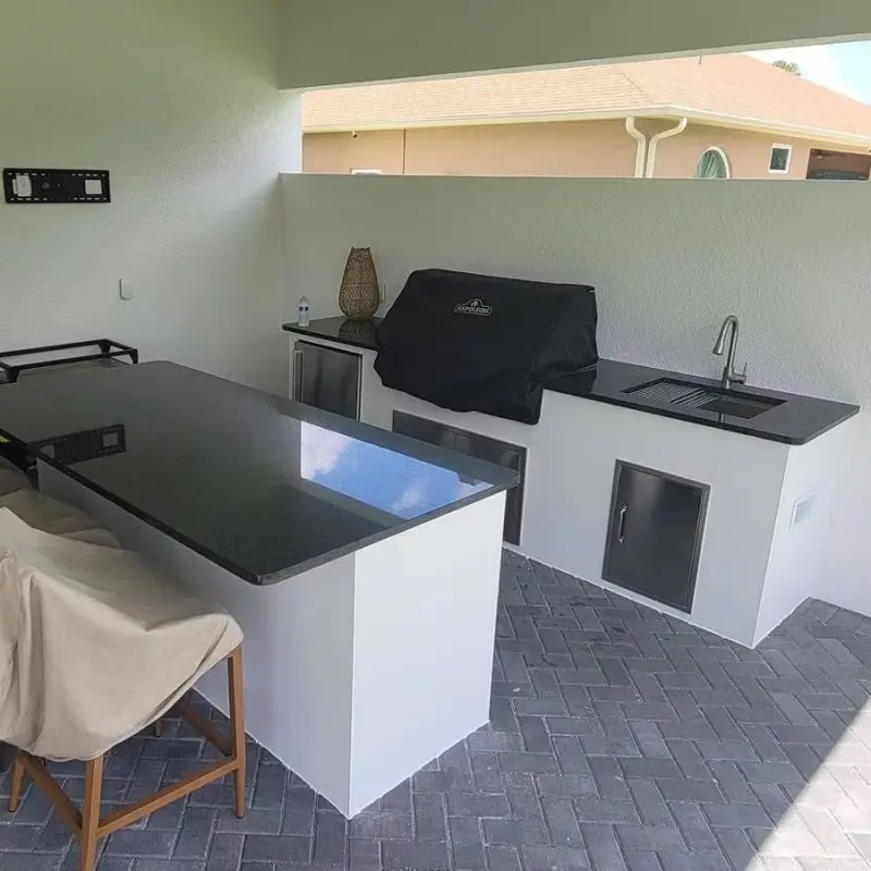Florida outdoor kitchen design featuring stone countertops and stainless grill