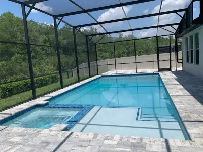Close-up of hurricane-rated pool screen Florida fasteners and aluminum beams